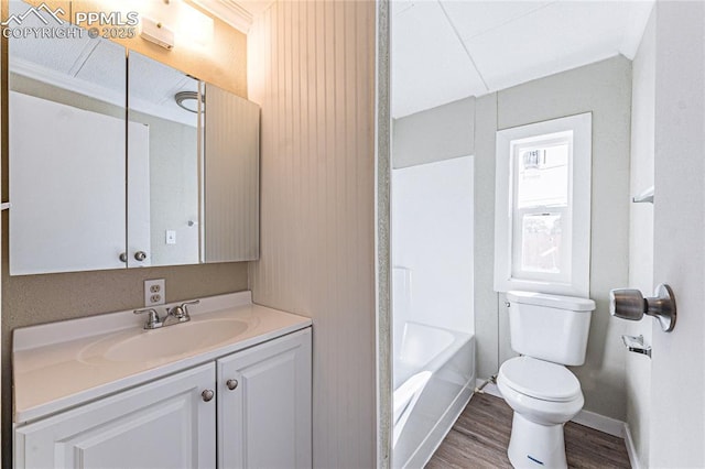 bathroom featuring ornamental molding, hardwood / wood-style flooring, vanity, and toilet