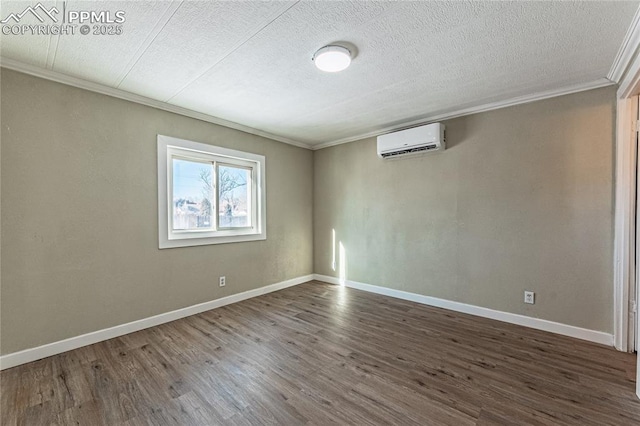 empty room with ornamental molding, a wall mounted air conditioner, a textured ceiling, and dark hardwood / wood-style floors