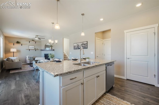 kitchen with white cabinetry, a center island with sink, ceiling fan, stainless steel dishwasher, and sink