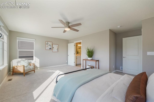 carpeted bedroom with ceiling fan and ensuite bathroom