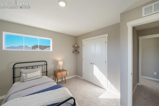 carpeted bedroom with a closet