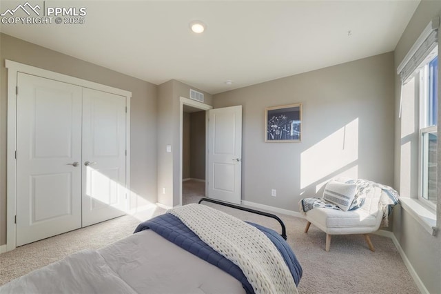 carpeted bedroom with a closet