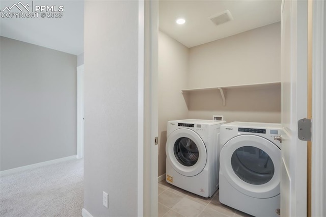 laundry room featuring separate washer and dryer and light colored carpet