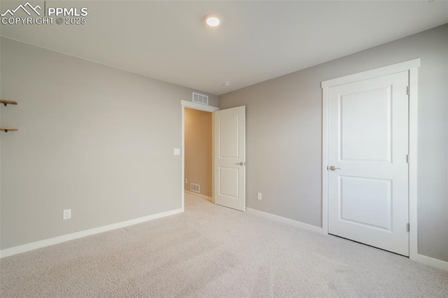 unfurnished bedroom featuring light colored carpet