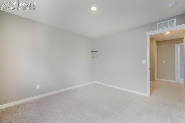 empty room featuring light carpet