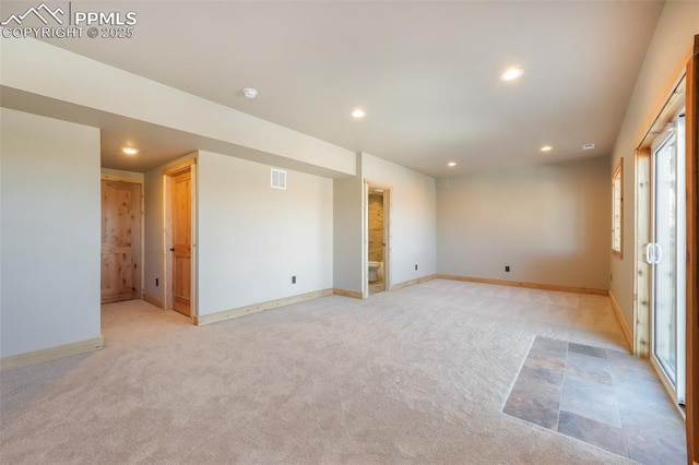 empty room featuring light carpet and a wealth of natural light