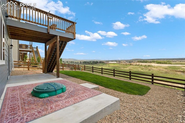 view of yard with a rural view and a patio area