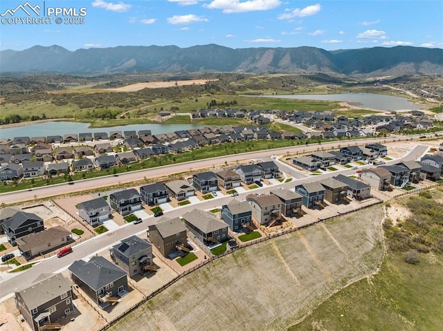 aerial view featuring a water and mountain view