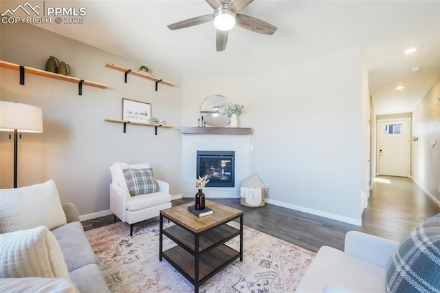 living room featuring ceiling fan and hardwood / wood-style floors