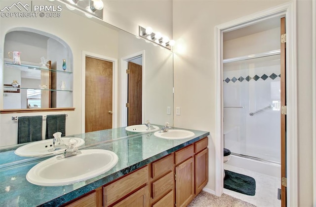 bathroom with a shower with door, toilet, and vanity