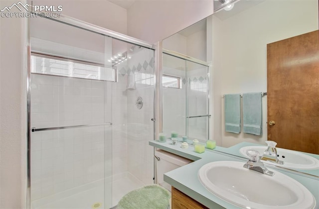 bathroom featuring vanity and a shower with door