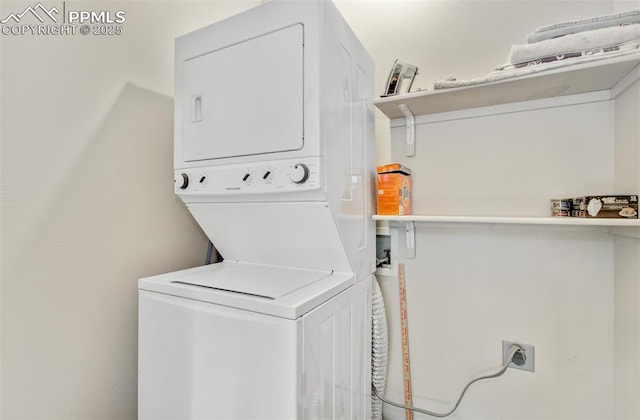 washroom featuring stacked washer and dryer