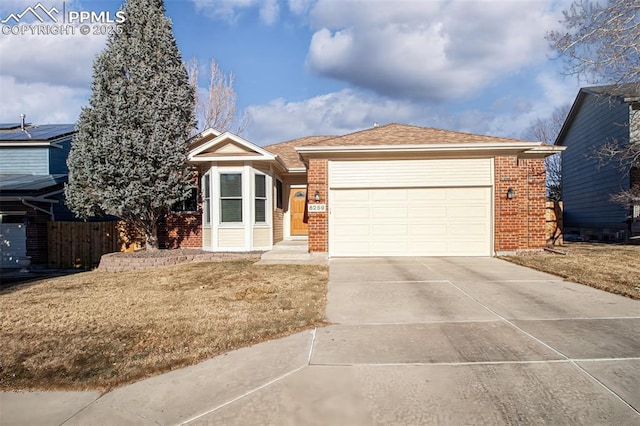 view of front facade with a garage and a front yard