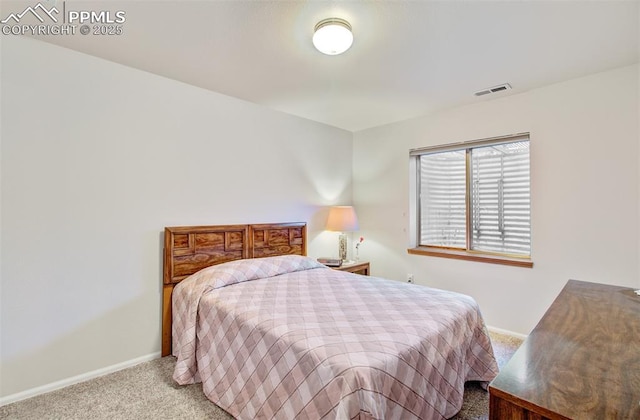 bedroom featuring light carpet