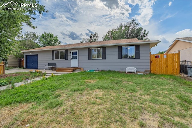 ranch-style home featuring a front lawn and a garage