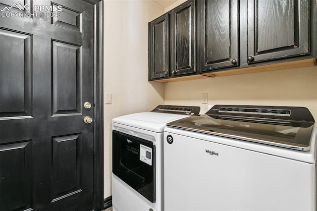 laundry room with cabinets and washer and dryer