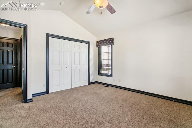 unfurnished bedroom featuring vaulted ceiling, a closet, ceiling fan, and carpet flooring