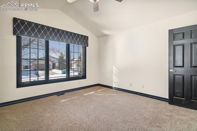 carpeted spare room with lofted ceiling and ceiling fan