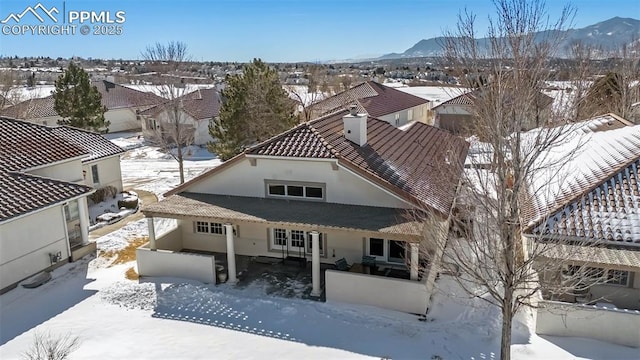 snowy aerial view with a mountain view