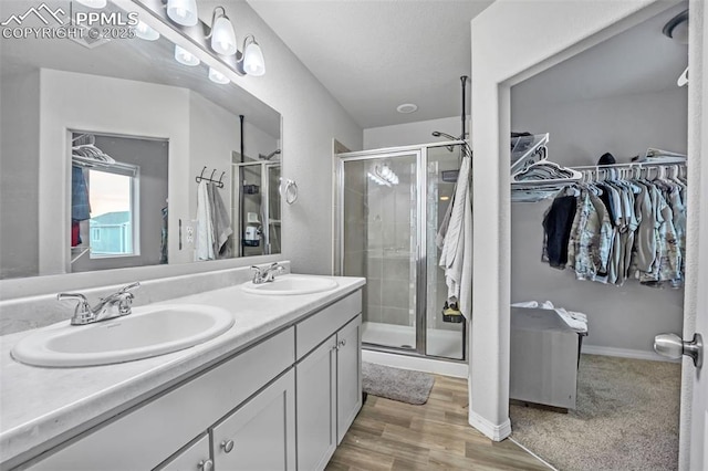 bathroom featuring vanity, a shower with shower door, and hardwood / wood-style flooring