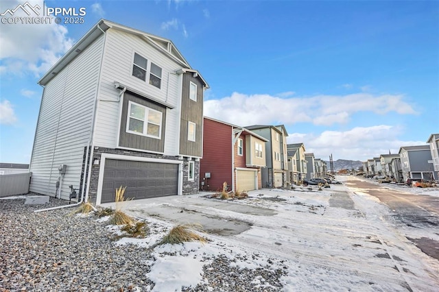 view of snow covered exterior featuring a garage