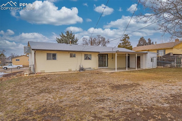 rear view of house featuring a patio and a yard