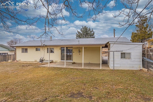 rear view of house featuring a yard and a patio area