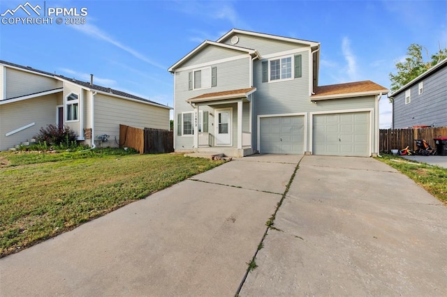 view of property featuring a front yard and a garage