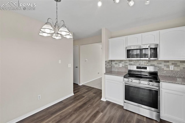 kitchen featuring stainless steel appliances, white cabinets, decorative backsplash, and hanging light fixtures