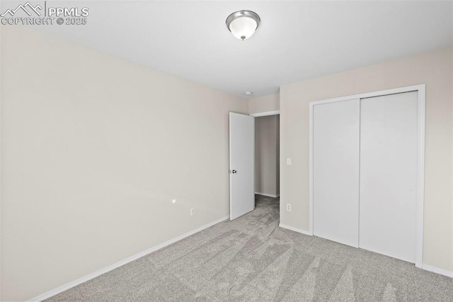 unfurnished bedroom featuring a closet and light carpet