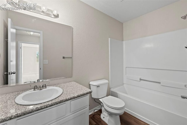 full bathroom featuring toilet, shower / washtub combination, wood-type flooring, and vanity