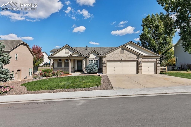 craftsman house featuring a front yard and a garage