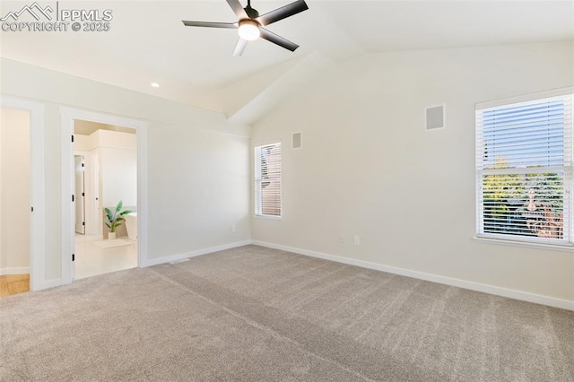 carpeted spare room featuring ceiling fan and lofted ceiling