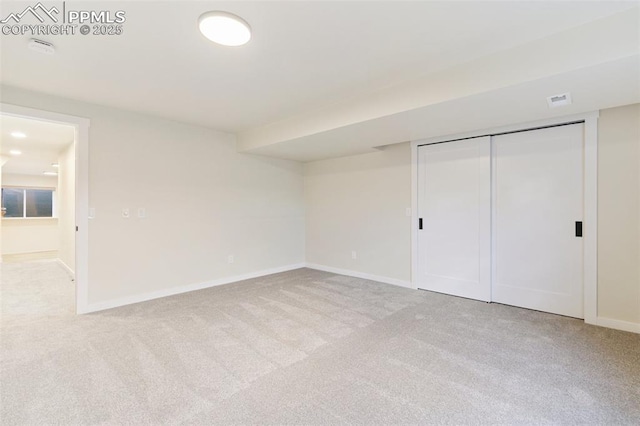 unfurnished bedroom featuring a closet and light carpet