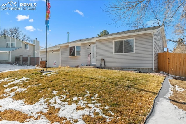 view of front of house featuring a garage and a yard