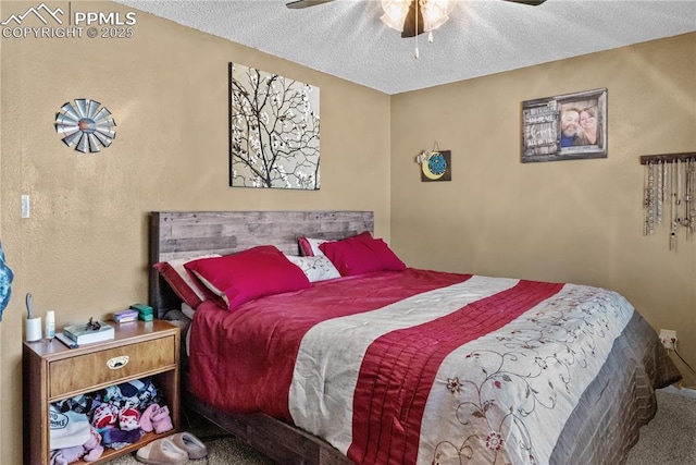 carpeted bedroom with a textured ceiling and ceiling fan