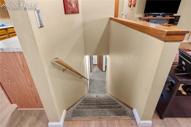 stairs with hardwood / wood-style floors