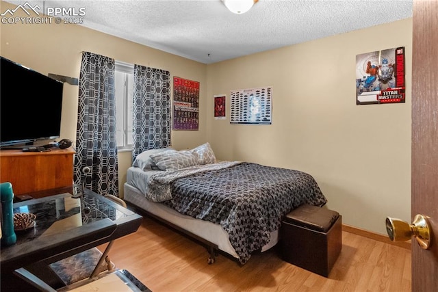 bedroom featuring a textured ceiling and hardwood / wood-style floors