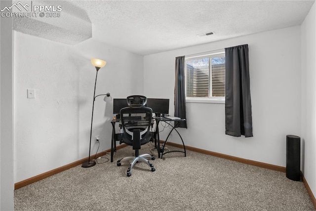 home office featuring carpet and a textured ceiling