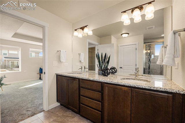 bathroom featuring an enclosed shower, vanity, and tile patterned floors