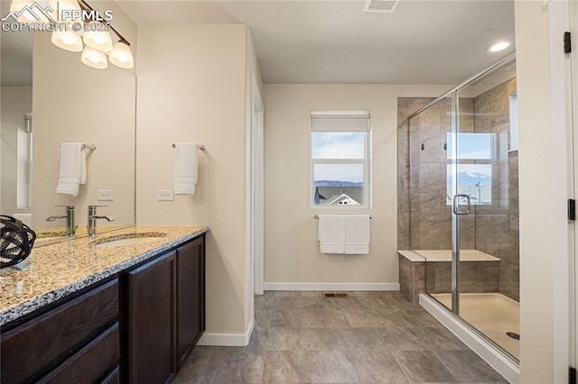 bathroom featuring walk in shower and vanity