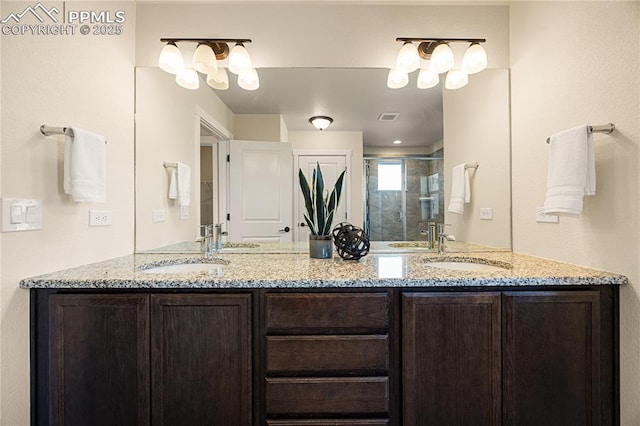 bathroom with vanity and a shower with door