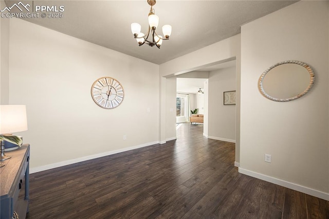 unfurnished dining area with dark wood-type flooring and a chandelier