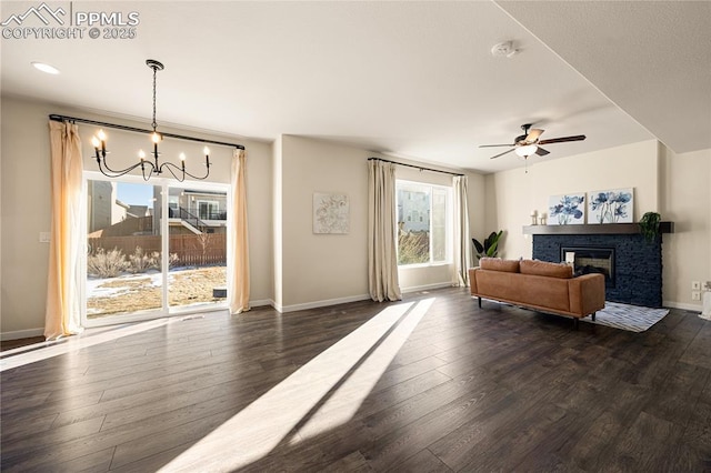 living room featuring dark wood-type flooring and ceiling fan with notable chandelier