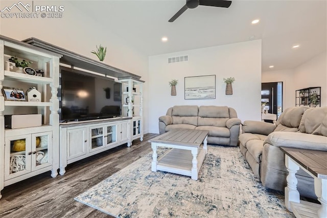 living room with dark hardwood / wood-style flooring and ceiling fan