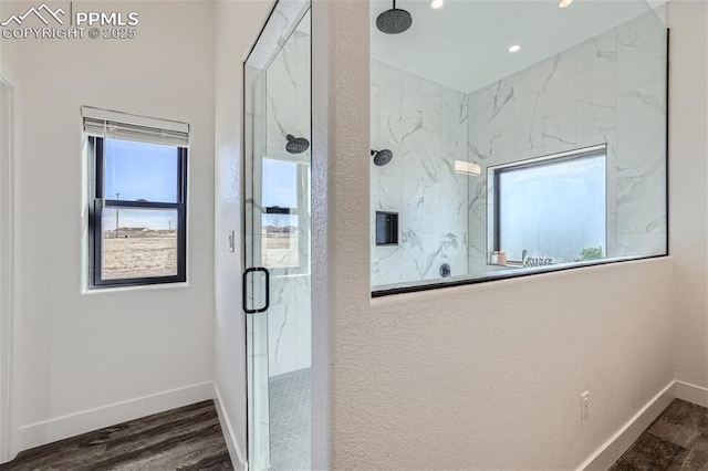 bathroom with hardwood / wood-style flooring and a shower with door