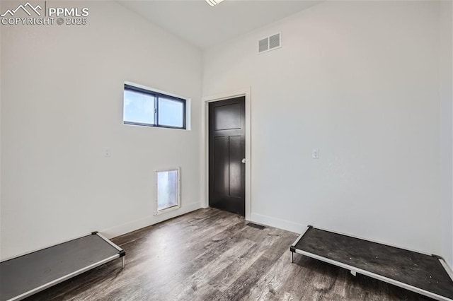 empty room with hardwood / wood-style floors