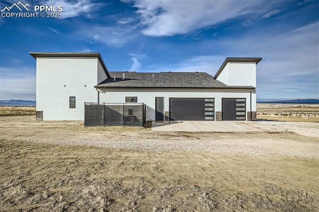 rear view of house featuring a garage