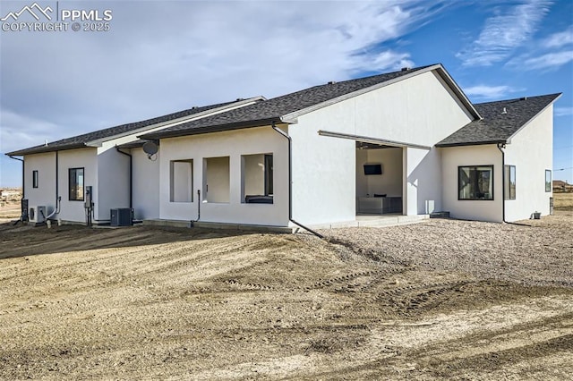 rear view of property with central air condition unit