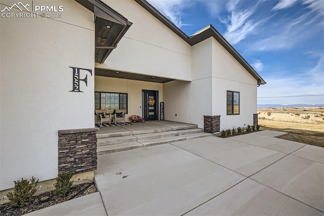 property entrance featuring a patio